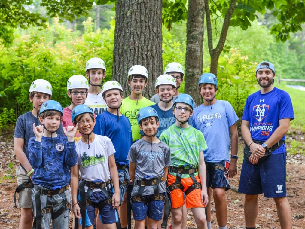 Group of boys wearing harnesses and helmets