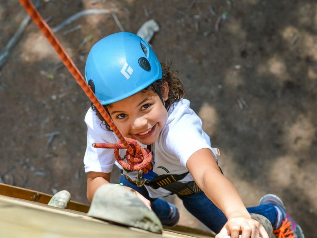 Girl climbing the rock tower
