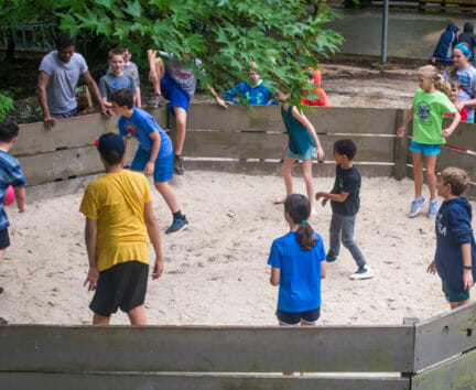 Boys playing a game of ga ga at camp