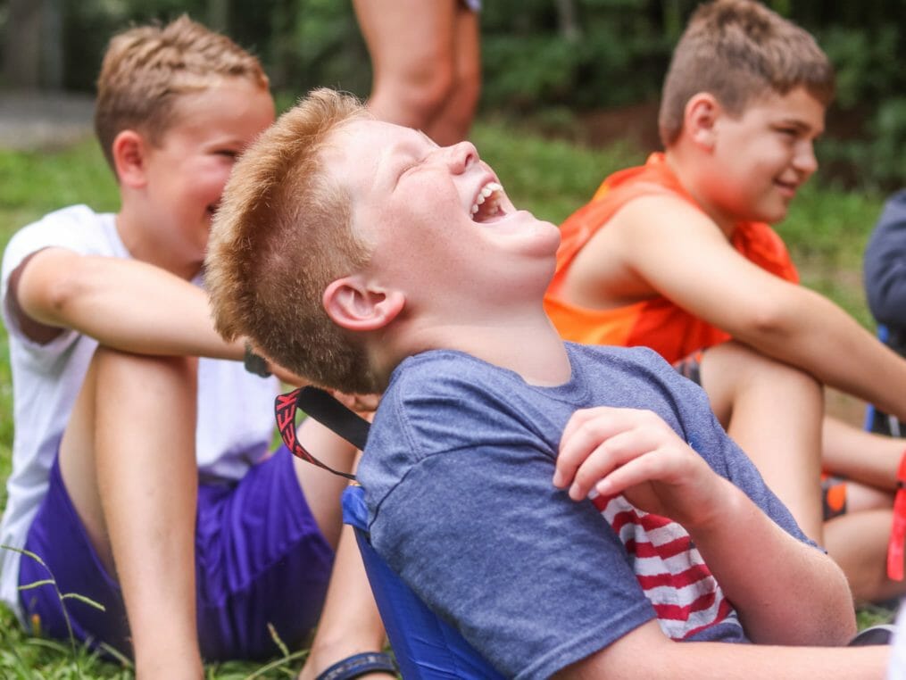 Boy laughing with friends