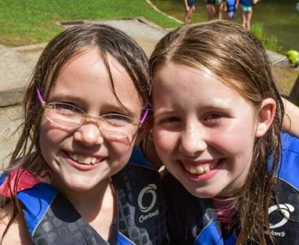 Two girls wearing life jackets at the Hendersonville Adventure Day Camp