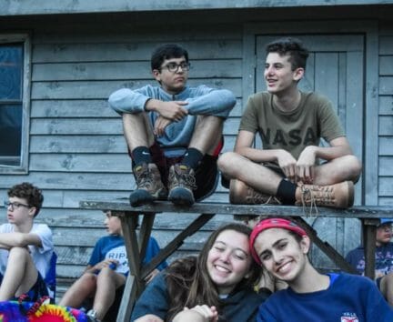 Campers in the evening relaxing on a picnic table