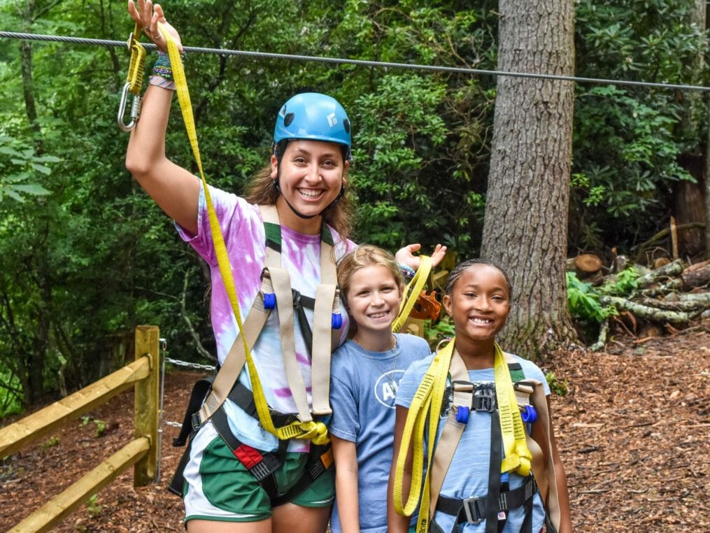 Staff and girls getting ready to zip line