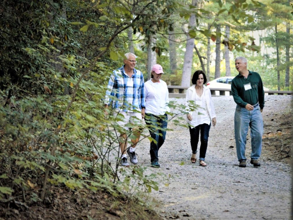 Four adults walking at camp