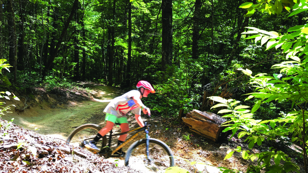 Camper riding a bike.